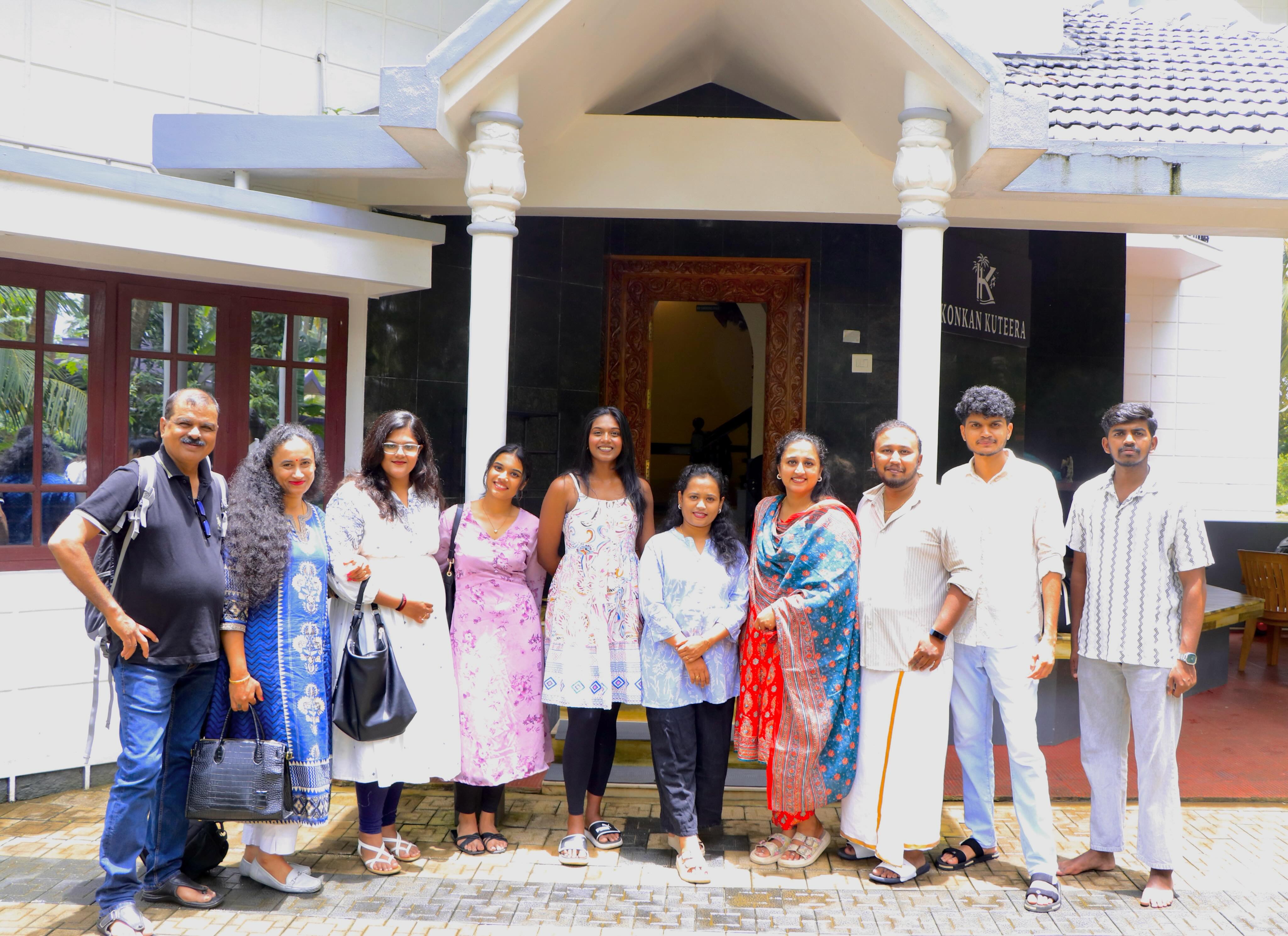 Large group of friends and family at the entrance porch of Konkan Kuteera 4BHK Villa